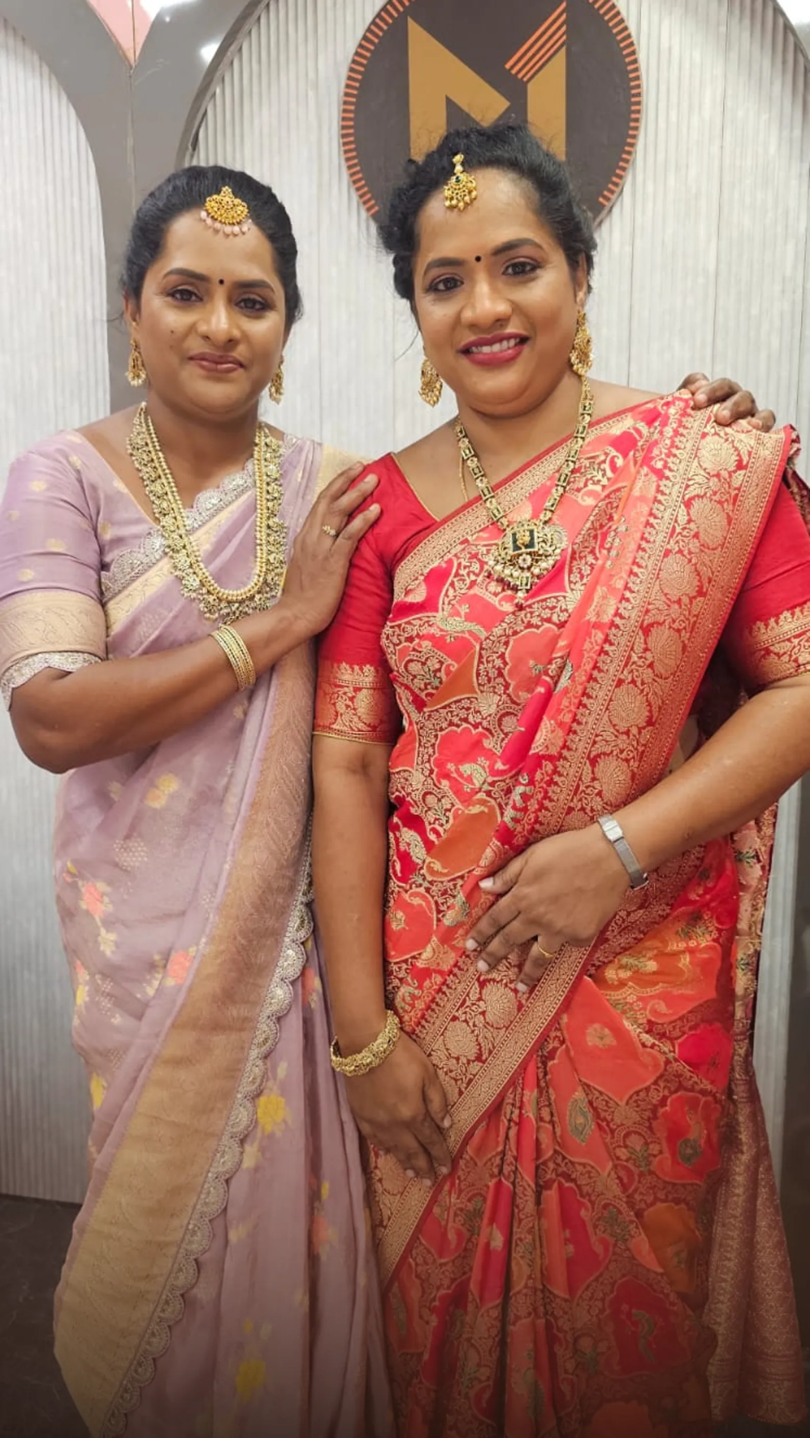 Two women in silk sarees at the Monalisa studio